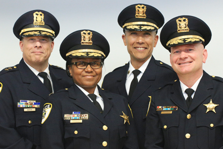 Photo of newly promoted Deputy Chief Joe Moran and Commanders Shatonya Johnson, Donicio Silva and Dave Jacobson.